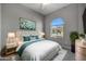 Bedroom with queen bed, window, and teal accents at 4275 E Bernice E St, Gilbert, AZ 85295