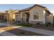Single story home with a tan stucco exterior, two-car garage, and drought-tolerant landscaping at 4275 E Bernice E St, Gilbert, AZ 85295