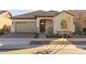 Tan two-car garage and front door with landscaping at 4275 E Bernice E St, Gilbert, AZ 85295