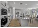 Open concept kitchen features an island, stainless steel appliances, and dining area at 4275 E Bernice E St, Gilbert, AZ 85295