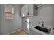 Laundry room with white cabinets, marble countertop, and sink at 4275 E Bernice E St, Gilbert, AZ 85295