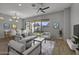Living room with light gray walls, hardwood floors, and staged furniture at 4275 E Bernice E St, Gilbert, AZ 85295
