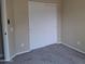 Simple bedroom with gray carpet and double door closet at 4841 S Vista Pl, Chandler, AZ 85248