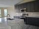 Modern kitchen with dark cabinetry, marble countertops, and stainless steel appliances at 4841 S Vista Pl, Chandler, AZ 85248