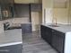 Modern kitchen with dark cabinetry, marble countertops, and stainless steel appliances at 4841 S Vista Pl, Chandler, AZ 85248