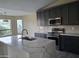 Modern kitchen with dark cabinetry, marble countertops, and stainless steel appliances at 4841 S Vista Pl, Chandler, AZ 85248