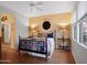 Cozy bedroom with hardwood floors, a comfortable bed, and large windows at 5450 E Mclellan Rd # 215, Mesa, AZ 85205