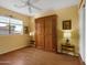 Bedroom with hardwood floors and built-in wooden cabinet at 5450 E Mclellan Rd # 215, Mesa, AZ 85205
