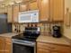 Close-up of kitchen stovetop and microwave at 5450 E Mclellan Rd # 215, Mesa, AZ 85205