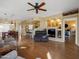 Spacious living room with hardwood floors, a built-in entertainment center, and views to kitchen and bedroom at 5450 E Mclellan Rd # 215, Mesa, AZ 85205