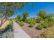 Landscaped walking path with lush plants and trees at 6060 S Antonio --, Mesa, AZ 85212
