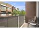 Private balcony overlooking a courtyard with seating for two at 6605 N 93Rd Ave # 1087, Glendale, AZ 85305