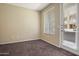 Bright bedroom featuring carpet floors and a private door at 6605 N 93Rd Ave # 1087, Glendale, AZ 85305