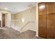 Bright hallway features carpet floors, modern railings, and a closet for extra storage at 6605 N 93Rd Ave # 1087, Glendale, AZ 85305