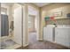 Convenient laundry room with washer, dryer, and built-in shelving at 6605 N 93Rd Ave # 1087, Glendale, AZ 85305