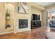 Bright living room features a fireplace, hardwood floors, and sliding glass door to balcony at 6605 N 93Rd Ave # 1087, Glendale, AZ 85305
