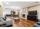 Open living room with hardwood floors, fireplace, and modern furniture at 6605 N 93Rd Ave # 1087, Glendale, AZ 85305