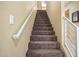 Carpeted stairs with a simple, modern railing at 6605 N 93Rd Ave # 1087, Glendale, AZ 85305