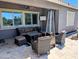 Relaxing covered patio features comfortable seating, a ceiling fan, and sun shades, perfect for outdoor living at 6616 W Side Canyon Trl, Phoenix, AZ 85083