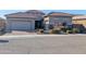 Charming single-story home with a well-maintained landscape, brick driveway, and a two-car garage at 6616 W Side Canyon Trl, Phoenix, AZ 85083