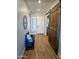 Inviting foyer with wood-look flooring, shiplap wall accents, and a rustic barn door at 6616 W Side Canyon Trl, Phoenix, AZ 85083