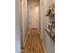 Hallway features laminate floors and neutral paint, enhanced by decorative shelving and an entry door at the end of the hallway at 6616 W Side Canyon Trl, Phoenix, AZ 85083