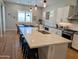 Open-concept kitchen with white cabinets, quartz countertops, and stainless steel appliances at 6616 W Side Canyon Trl, Phoenix, AZ 85083