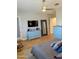 Bright main bedroom showcasing two dressers, TV, and access to outdoor patio at 6616 W Side Canyon Trl, Phoenix, AZ 85083
