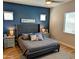 Stylish main bedroom with a tufted headboard, side tables, and ample natural light at 6616 W Side Canyon Trl, Phoenix, AZ 85083