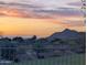 Enjoy breathtaking sunset mountain views from this home's manicured backyard, complete with a secure black iron fence at 6616 W Side Canyon Trl, Phoenix, AZ 85083
