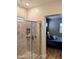Glass enclosed shower with tile surround adjacent to modern bedroom at 6616 W Side Canyon Trl, Phoenix, AZ 85083