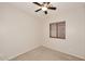 Well-lit bedroom featuring a ceiling fan and window blinds at 6657 E Regina St, Mesa, AZ 85215