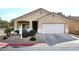 Tan house with white garage door and landscaping at 6657 E Regina St, Mesa, AZ 85215