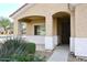 House entrance with covered porch and wrought iron door at 6657 E Regina St, Mesa, AZ 85215