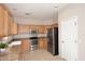 Bright kitchen featuring stainless steel appliances and light wood cabinets at 6657 E Regina St, Mesa, AZ 85215