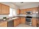 Kitchen with stainless steel appliances and light wood cabinets at 6657 E Regina St, Mesa, AZ 85215