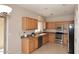 Kitchen with wood cabinets and stainless steel appliances at 6657 E Regina St, Mesa, AZ 85215
