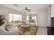 Bright living room with a ceiling fan, neutral walls, and view of the dining area at 6657 E Regina St, Mesa, AZ 85215