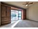 Spacious bedroom with built-in wooden wardrobes and backyard access at 7833 S Terrace Rd, Tempe, AZ 85284