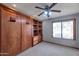 Bedroom with built-in wooden wall unit and shelves at 7833 S Terrace Rd, Tempe, AZ 85284