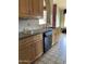 Kitchen with granite countertops, light wood cabinets, and a dishwasher at 7833 S Terrace Rd, Tempe, AZ 85284