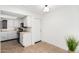 Bright kitchen with white cabinets and door to outside at 9714 E Indiana Ave, Sun Lakes, AZ 85248