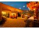 Outdoor kitchen and seating area under a pergola with string lights at 9781 S 182Nd Dr, Goodyear, AZ 85338