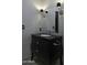 Elegant bathroom with black vanity and modern fixtures at 10040 N 78Th Pl, Scottsdale, AZ 85258