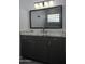 Modern bathroom with marble countertop and dark cabinets at 10040 N 78Th Pl, Scottsdale, AZ 85258
