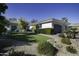 Landscaped front yard with artificial turf and mature shrubs at 10040 N 78Th Pl, Scottsdale, AZ 85258