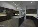 Modern kitchen with dark cabinetry, marble island, and high-end appliances at 10040 N 78Th Pl, Scottsdale, AZ 85258