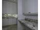 Bright laundry room featuring granite countertops and ample cabinetry at 10040 N 78Th Pl, Scottsdale, AZ 85258