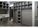 Large walk-in closet with custom shelving and hanging space at 10040 N 78Th Pl, Scottsdale, AZ 85258