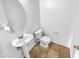 Small half bathroom with pedestal sink and tile floor at 12517 W Rosewood Dr, El Mirage, AZ 85335